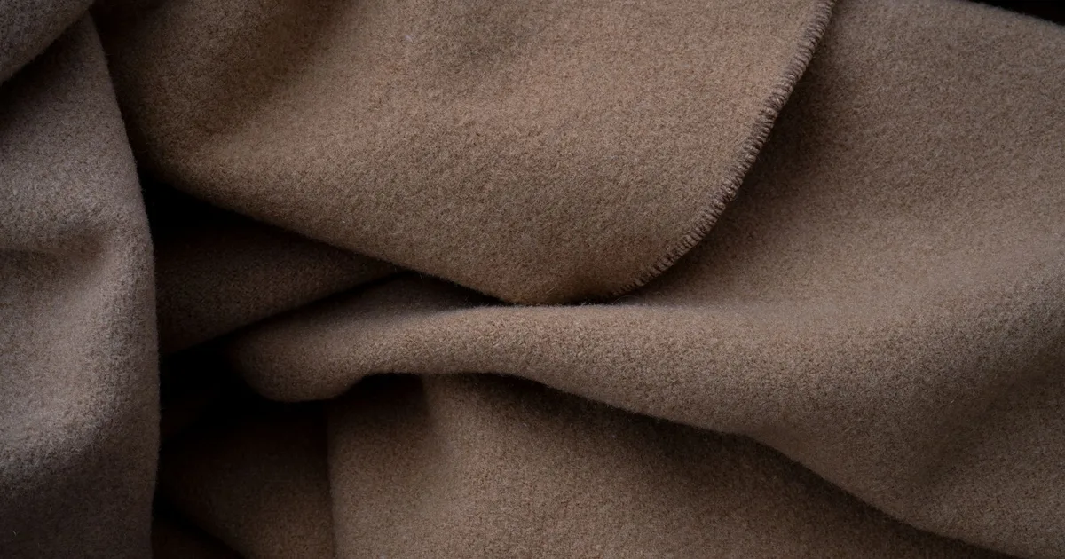 Close-up of a soft brown fabric, ideal for cozy and warm-themed projects.